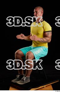 Sitting reference of whole yellow shirt turquoise shorts brown shoes…